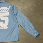 PVTLTD* Rush Hour Blue Shirt at an angle on concrete, oversized back graphic