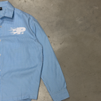 Front of the PVTLTD* Rush Hour Blue Shirt on concrete, full sleeve and cuff