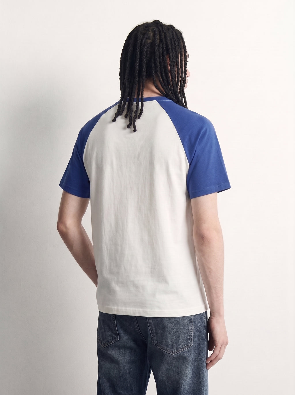 Blue Raglan Tee back on model, plain off-white body with royal blue raglan sleeves, PVTLTD*