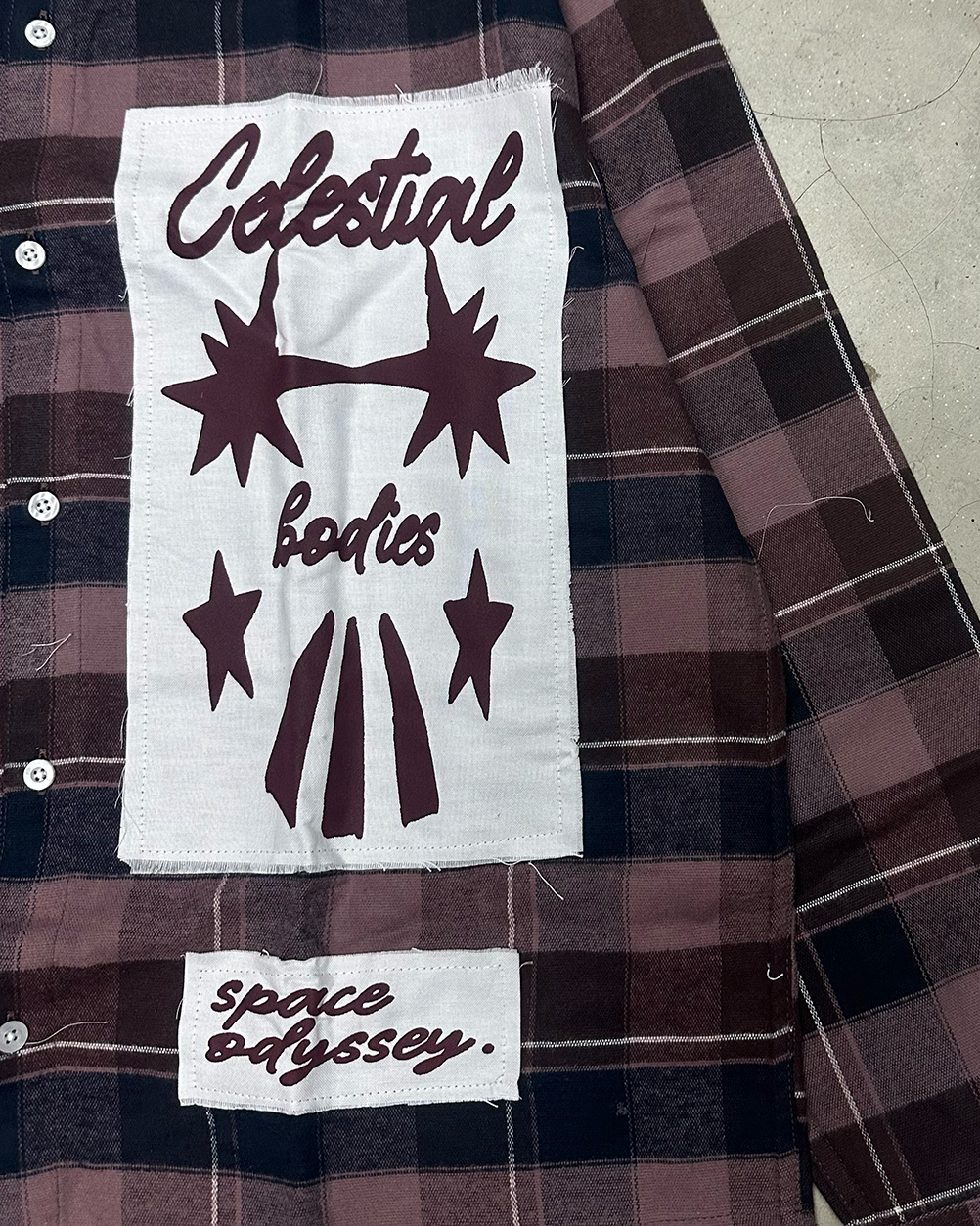 Close-up of the raw-edge Celestial Bodies and space odyssey patches, PVTLTD* Cosmic Flannel