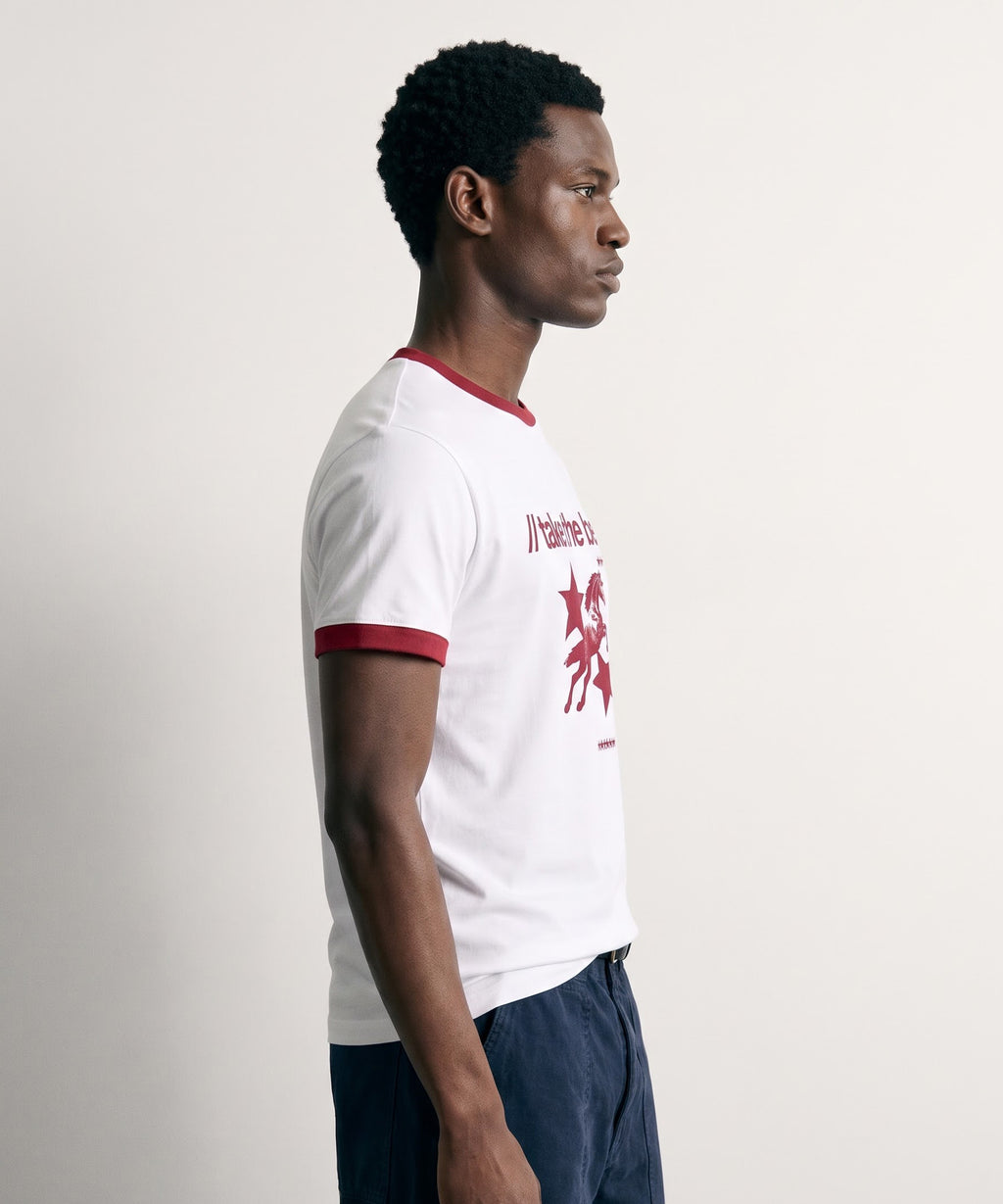 Side profile of the PVTLTD* Horsebet Slim Fit Tee, showing the red ringer collar and sleeve trim on the model
