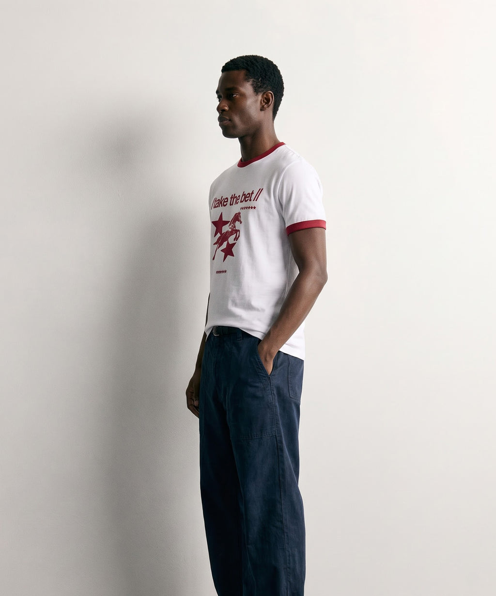 PVTLTD* Horsebet Slim Fit Tee worn with navy trousers, three-quarter side view showing the slim fit