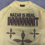 Close-up of the Nazar is real innnnnnit print on the PVTLTD* Nazar Tee