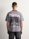 Mansion Tee back on model, oversized pink Mansion script over a mansion illustration, PVTLTD*