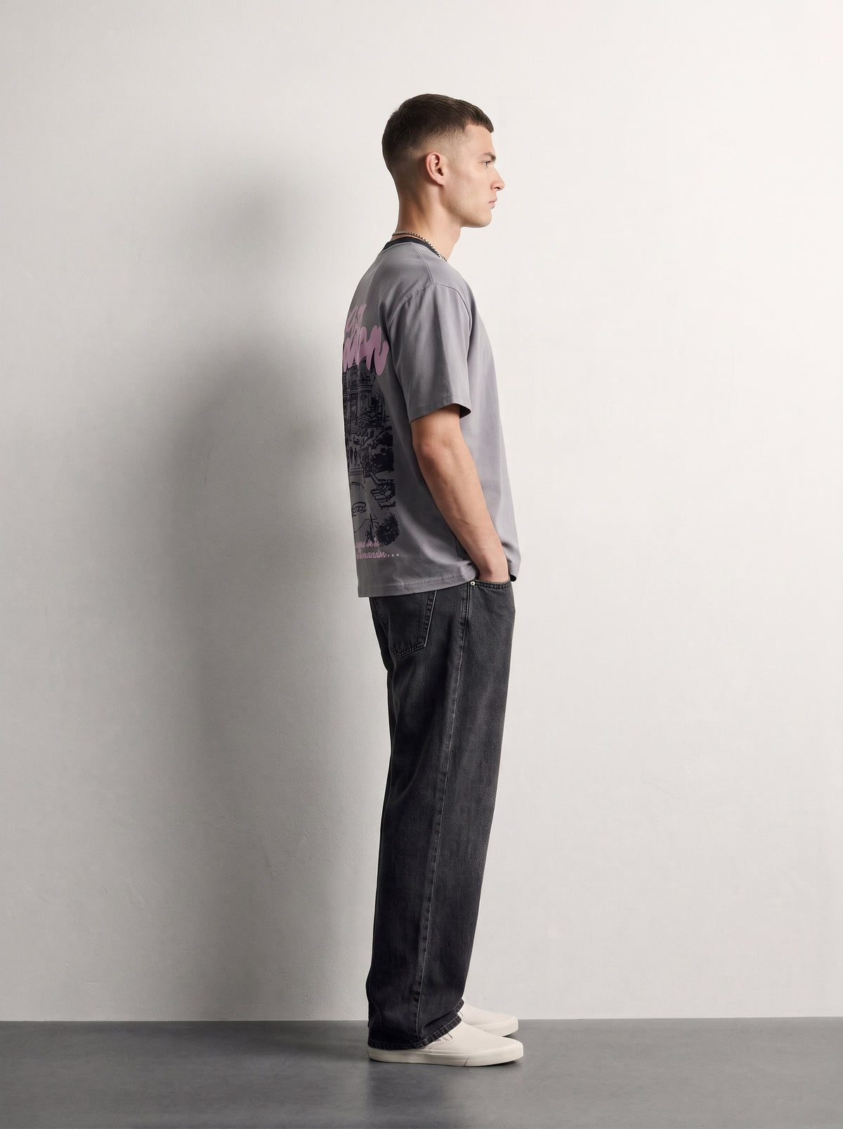 PVTLTD* Mansion Tee side view on model, boxy fit with the back print wrapping