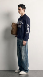 PVTLTD* Navy Legacy Polo side view on model, white tribal print running down the sleeve