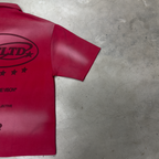 Back of the PVTLTD* Legacy Shirt at an angle on concrete, distressed crimson wash