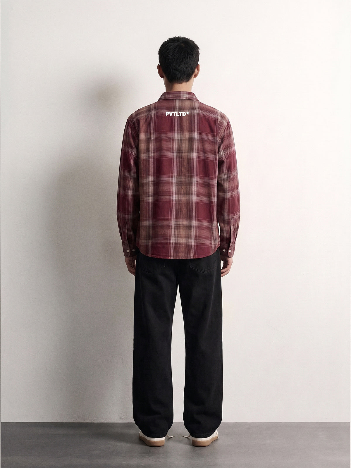 Red Checks Shirt back on model, white PVTLTD* print across the upper back
