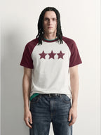 PVTLTD* Red Raglan Tee, close-up of the speckled three-star chest print on the off-white body