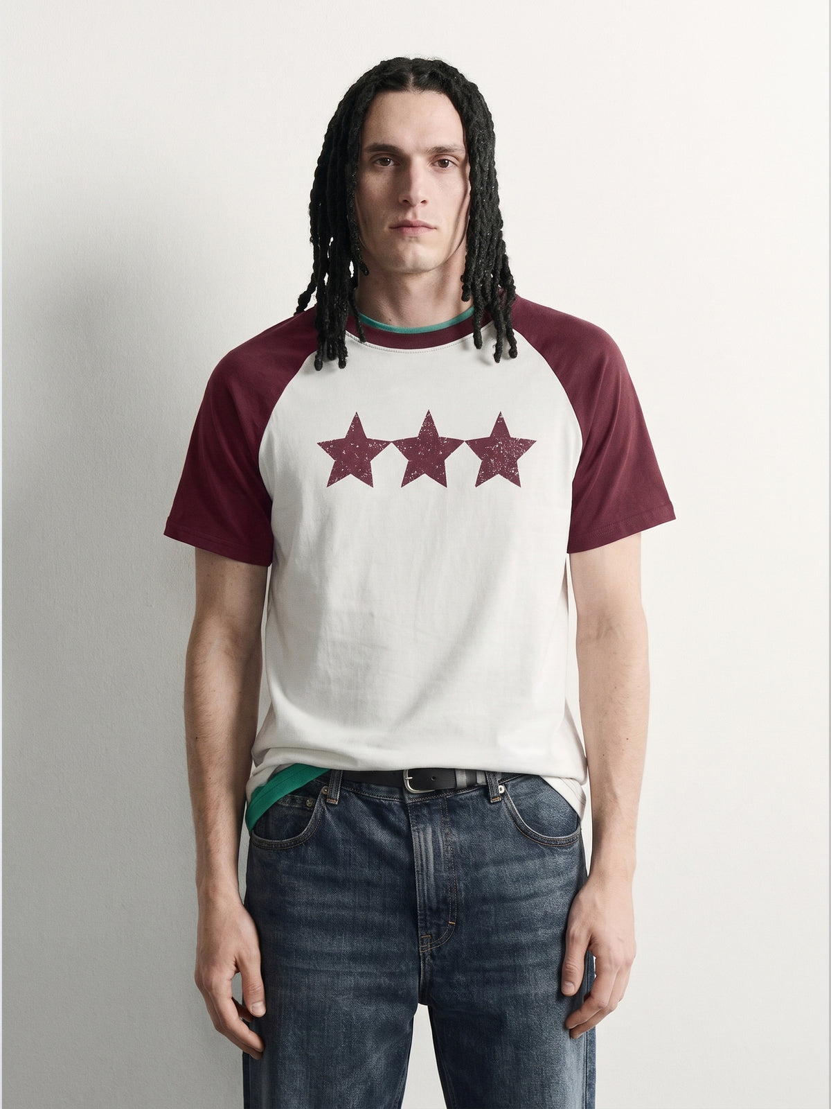 PVTLTD* Red Raglan Tee, close-up of the speckled three-star chest print on the off-white body